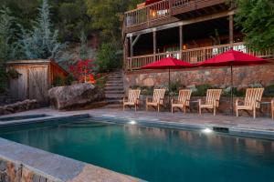 a pool with chairs and umbrellas in front of a house at Inn Wine Country - Summers House in Sonoma