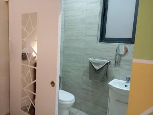a bathroom with a toilet and a sink at NJ Stay Gozo in Għajnsielem