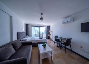 a living room with a couch and a table at İlya Apart 2 in Bodrum City