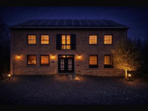 a house with a solar panel on the front of it at night at Le Bovary Hotel Riad in Héron