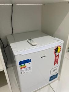 a white refrigerator with a phone on top of it at Pousada Riocabana in Barreirinhas