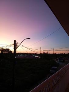 a sunset from a balcony with a street light at Pousada Riocabana in Barreirinhas