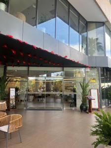 a large glass building with tables and chairs in it at AHoa StarCity with Seaview in Nha Trang