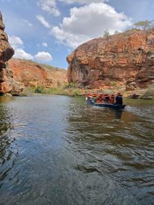 a group of people in a boat on a river at Pousada Mayer in Paulo Afonso