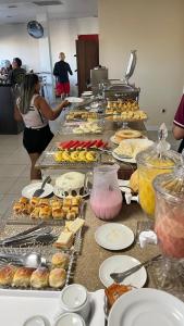 a buffet line with many different types of pastries at Pousada Mayer in Paulo Afonso