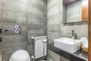 a bathroom with a white toilet and a sink at Stunning 4 Bedroom Duplex in Kfardebian +42 photos