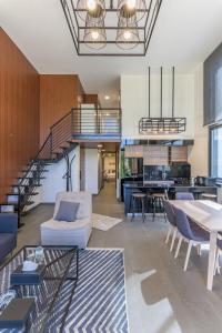 a living room with a staircase and a dining room at Stunning 4 Bedroom Duplex in Kfardebian