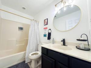 a bathroom with a sink and a toilet and a mirror at HotTub|Sauna|Theater|BBQ|Firepit|Game|Pool in Long Pond +23 photos