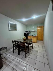 a kitchen with a table and chairs in a room at Downtown Suite Wifi in Morelia +8 photos