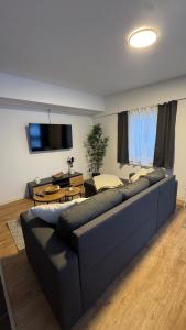 a living room with a couch and a flat screen tv at SchrauberStube Bertkow in Goldbeck
