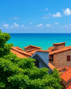a view of the ocean from the roofs of houses at Espaço Verão Vermelho in Cabo Frio