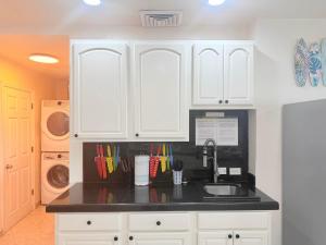 a kitchen with white cabinets and a sink at Las Palmas 4BR 4BA Penthouse OV 701 in Campo del Medio +69 photos
