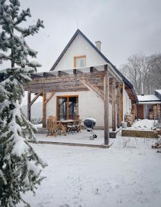 a log home with a grill in the snow at Chata Eva in Jičín