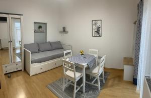 a small room with a bed and a table and chairs at Dům na jihu Valtice in Valtice