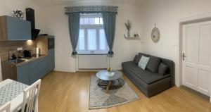 a living room with a couch and a table at Dům na jihu Valtice in Valtice +33 photos
