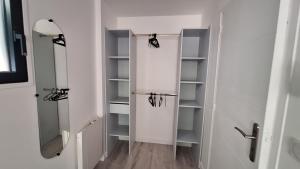 a walk in closet with empty shelves in a bathroom at La Valiette in La Seyne-sur-Mer +6 photos