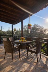 a patio with a table and chairs on a deck at Elia & Petra Villa in Prinos