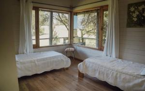 a bedroom with two beds and a large window at Casa en Las Perdices, Carmelo in Carmelo +49 photos