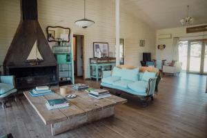 a living room with a couch and a coffee table at Casa en Las Perdices, Carmelo in Carmelo