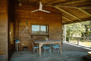 a wooden deck with a table and chairs on it at Casa en Las Perdices, Carmelo in Carmelo