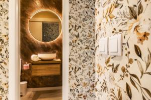 a bathroom with a mirror and a sink at Cidadela do Viriato Deluxe in Viseu