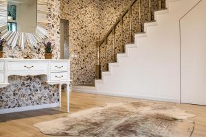 a room with a white dresser and a staircase at Cidadela do Viriato Deluxe in Viseu