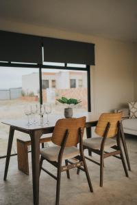 a dining room table with two chairs and a potted plant at Casas VV in Valle de Guadalupe +22 photos