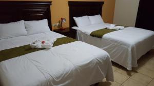 Ένα ή περισσότερα κρεβάτια σε δωμάτιο στο Apart Hotel Pico Bonito