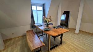a dining room table with a vase of flowers on it at Apartment am Ostorfer See in Schwerin