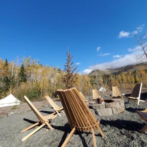 a group of chairs sitting on top of a fire pit at Alaskan Glamping in Anchorage +24 photos