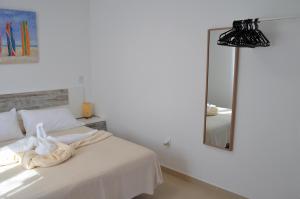 a bedroom with a white bed and a mirror at Sand & Beach in Pájara