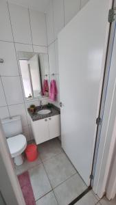 a bathroom with a toilet and a sink and a mirror at Casa Holambra Van den Broek in Holambra