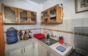 a small kitchen with a sink and a counter at Ocean Blue in Huanchaco