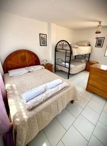 a bedroom with two beds and two bunk beds at Ocean Blue in Huanchaco