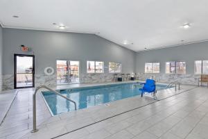 a swimming pool with a blue chair in a building at Best Western Montrose Inn in Montrose