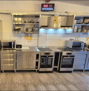 a kitchen with stainless steel appliances in a kitchen at Pension Mediterrano - Monteurzimmer in Bedburg