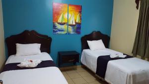Ένα ή περισσότερα κρεβάτια σε δωμάτιο στο Apart Hotel Pico Bonito