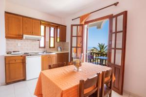a kitchen with a table with a table cloth on it at Maria Apartments in Amoopi
