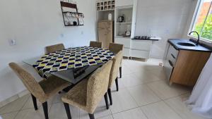 a kitchen with a table and chairs in a kitchen at Casa da vó cida in Itapoa