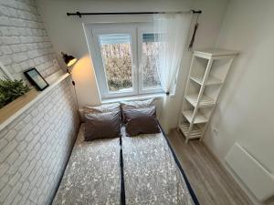 a small room with a couch in front of a window at Avar Inn in Tiszalök