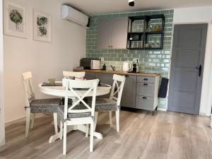 a kitchen with a table and chairs in a room at Avar Inn in Tiszalök