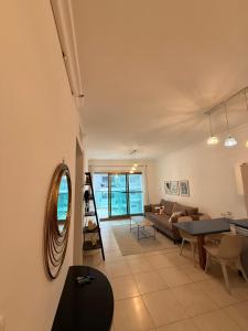 a living room with a couch and a table at נוף ראשון לים in Ashkelon