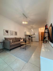 a living room with a couch and a table at נוף ראשון לים in Ashkelon
