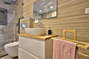 a bathroom with a sink and a toilet at סוויטות חוף האהבה in Haifa