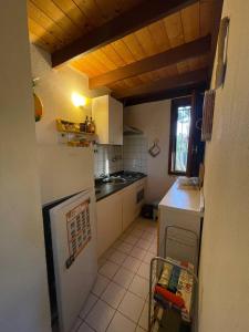 a kitchen with a white refrigerator and a stove at Villa Celeste in Torre delle Stelle