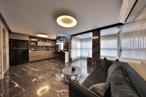a living room with a couch and a table at סוויטות חוף האהבה in Haifa +4 photos