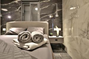 a bedroom with a bed with towels on it at סוויטות חוף האהבה in Haifa