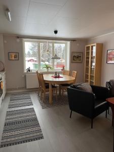 a living room with a dining room table and chairs at Villa nära Järvsö in Järvsö