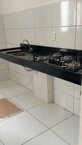 a kitchen counter with a stove top in a kitchen at Casa condominio Reserva do Delta 07 in Parnaíba
