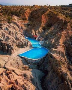 an aerial view of a dam on a rocky mountain at Proyecto tour yuma tatacoa in Villavieja